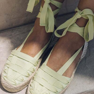 Woman wearing lime green lace up espadrille sandals